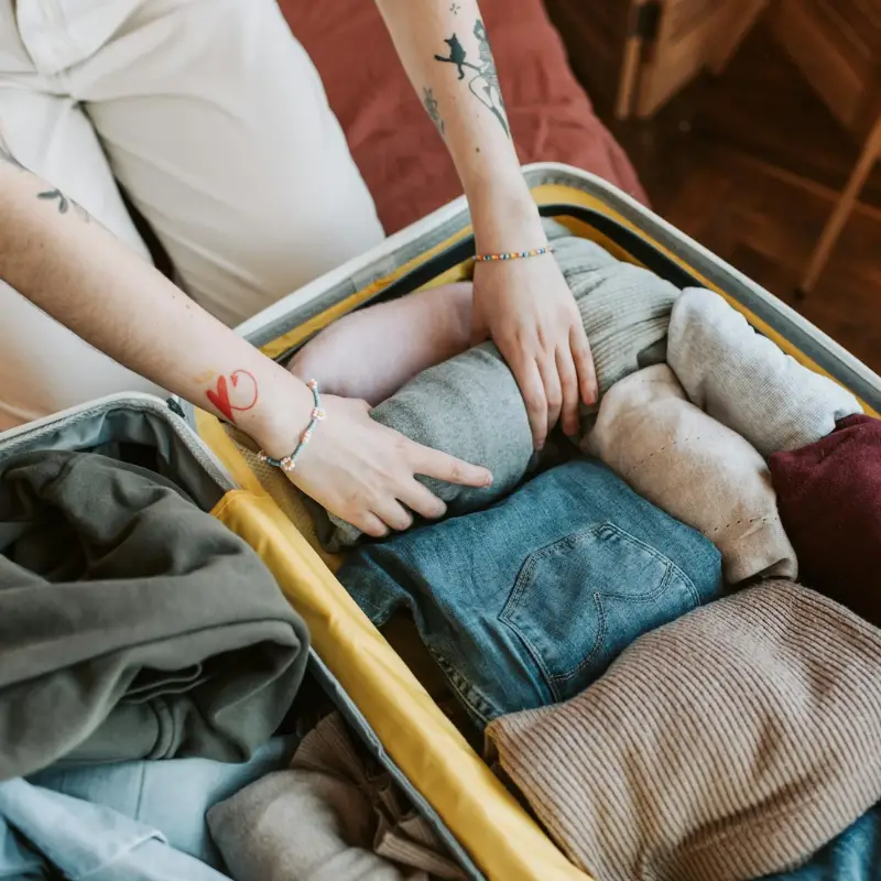 Person Packing a Luggage