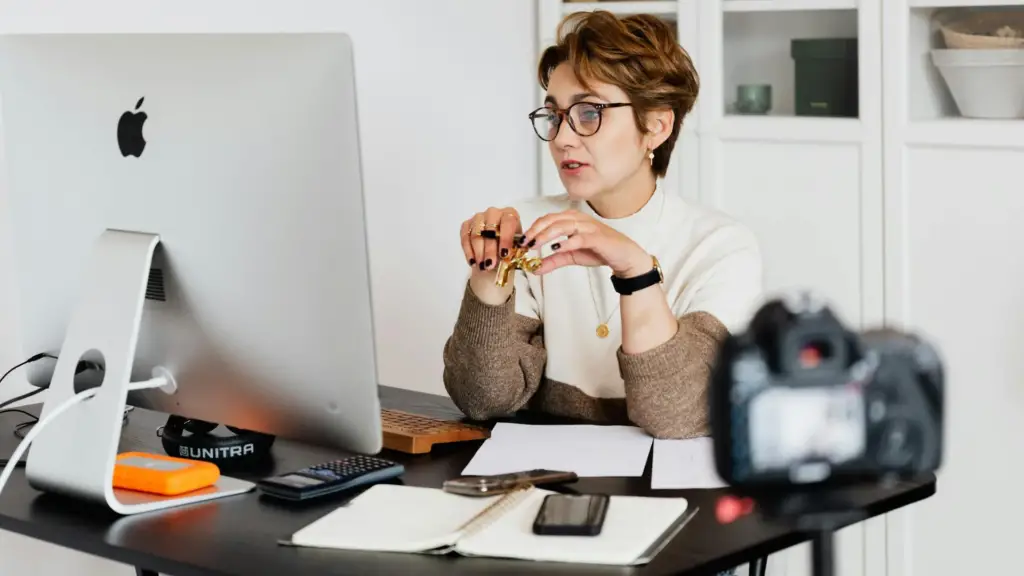 confident-elegant-lady-in-eyeglasses-hosting-webinar