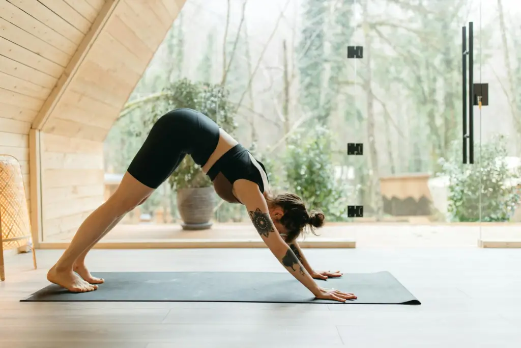 a-woman-bending-forward-on-the-yoga-mat