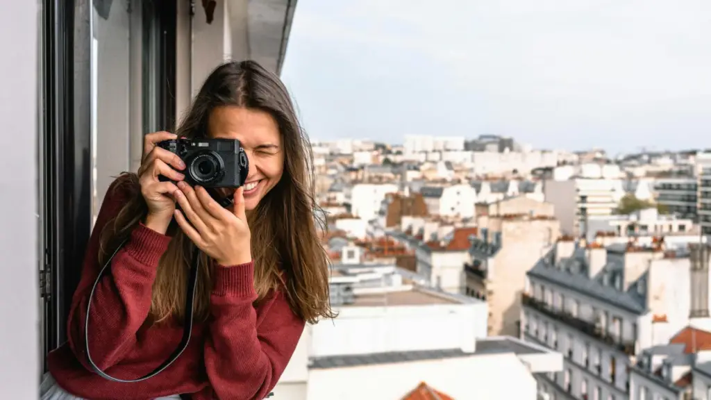 woman-smiling-holding-camera